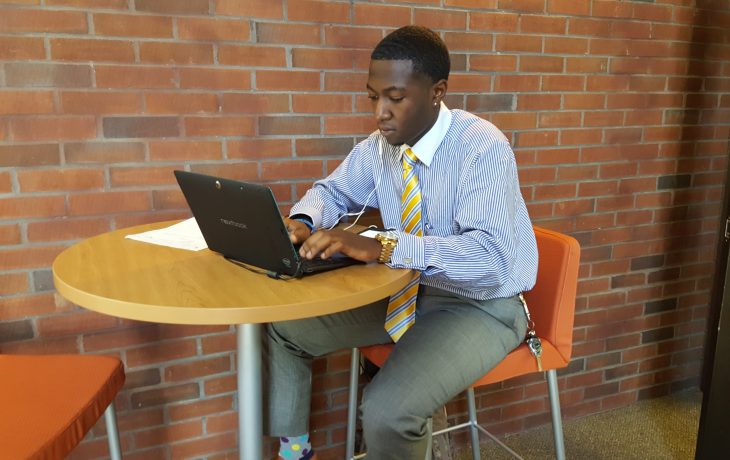 Student working at laptop in library
