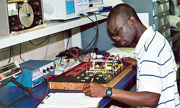 Electronics engineering student tinkering with a breadbox