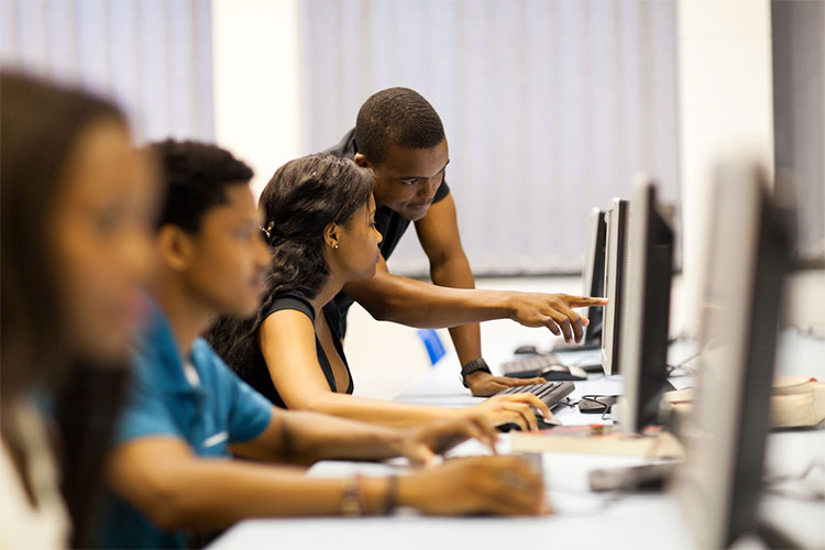 Students on computers with instructor