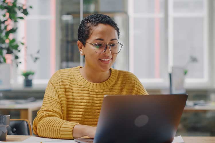 young woman working at a laptop computer