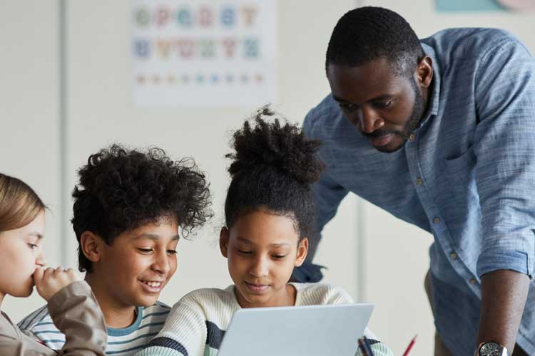 teacher working with middle grade students