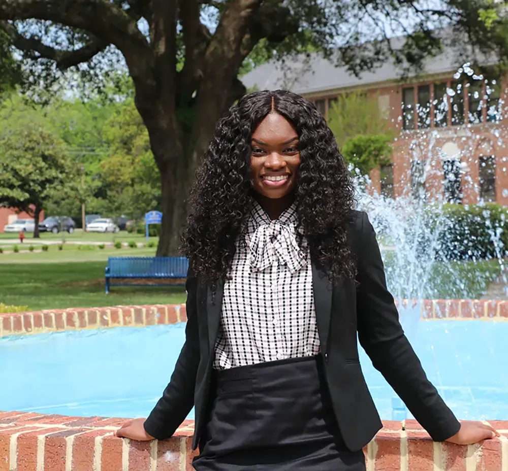 FVSU Student posing by the water fountain